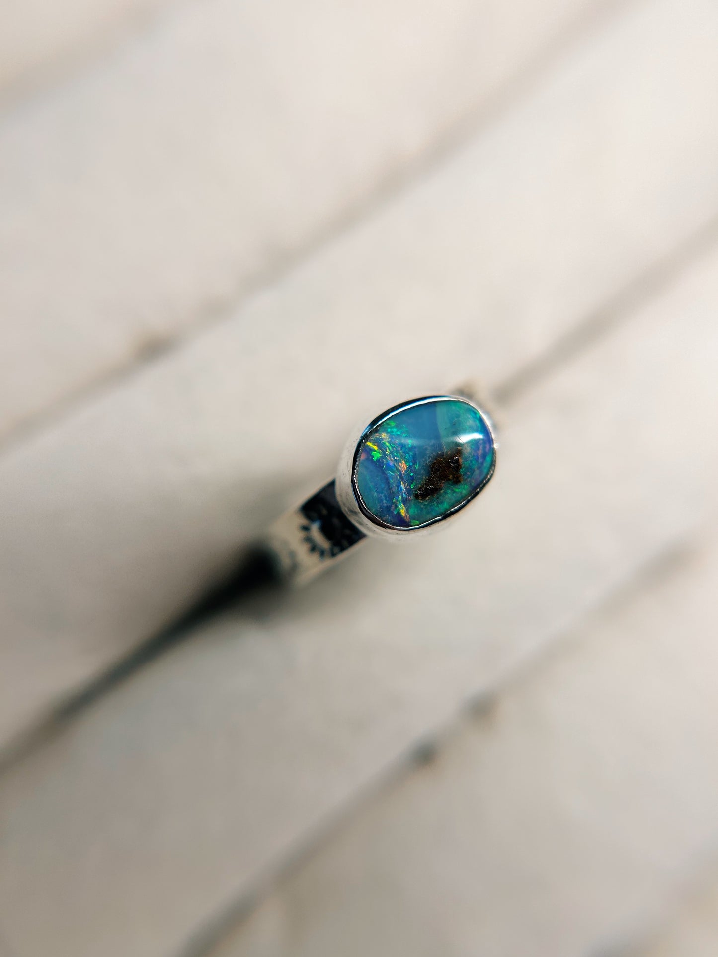 Petite size 5 boulder opal ring with sunburst band