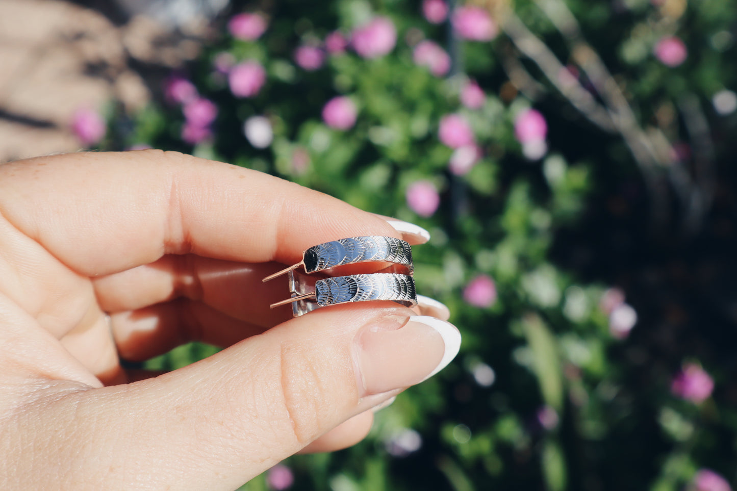 Hand stamped sterling silver “Fish tail” hoop earrings.
