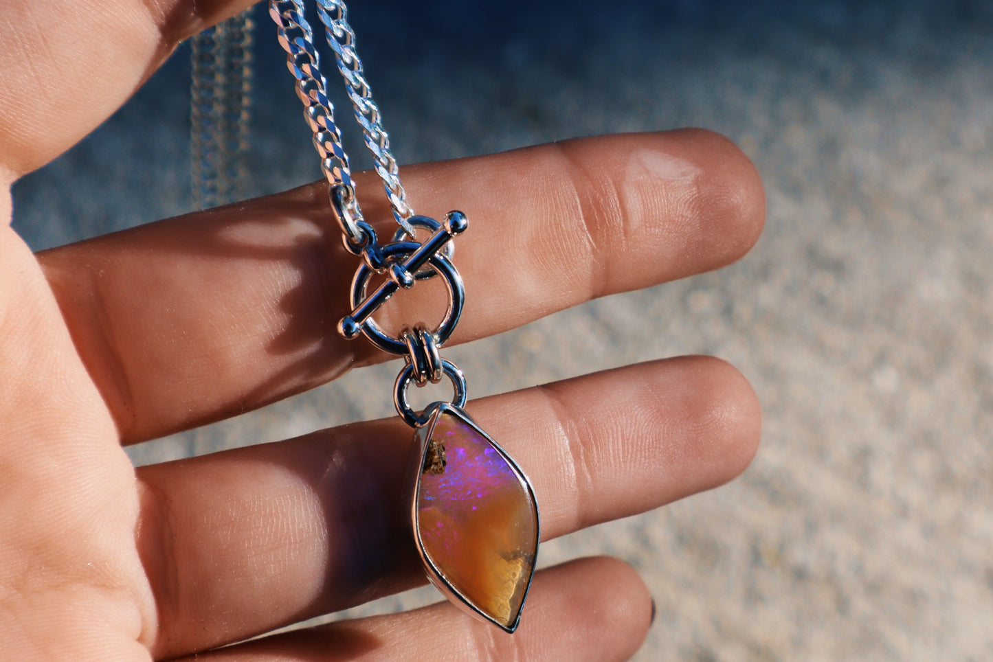 Stunning purple and caramel boulder opal toggle pendant. Sterling silver, 18 inches, diamond cut curb chain.