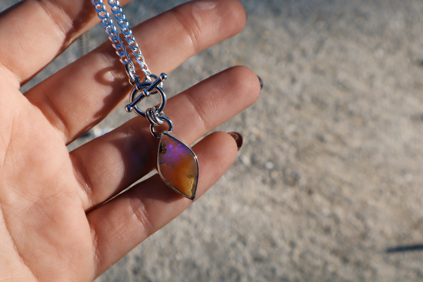 Stunning purple and caramel boulder opal toggle pendant. Sterling silver, 18 inches, diamond cut curb chain.