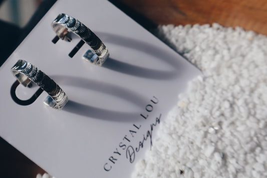 Hand stamped sterling silver “Fish tail” hoop earrings.