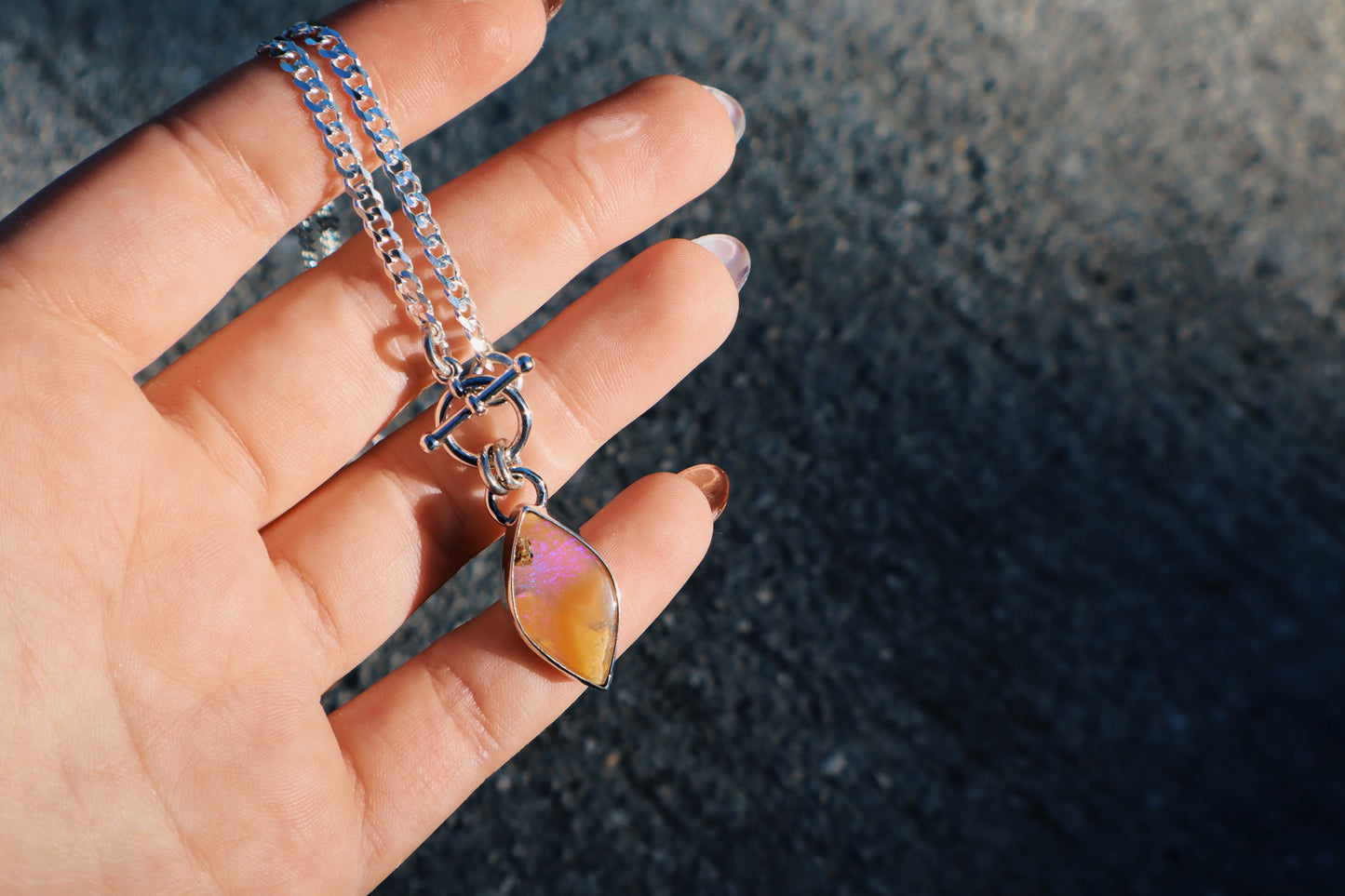 Stunning purple and caramel boulder opal toggle pendant. Sterling silver, 18 inches, diamond cut curb chain.
