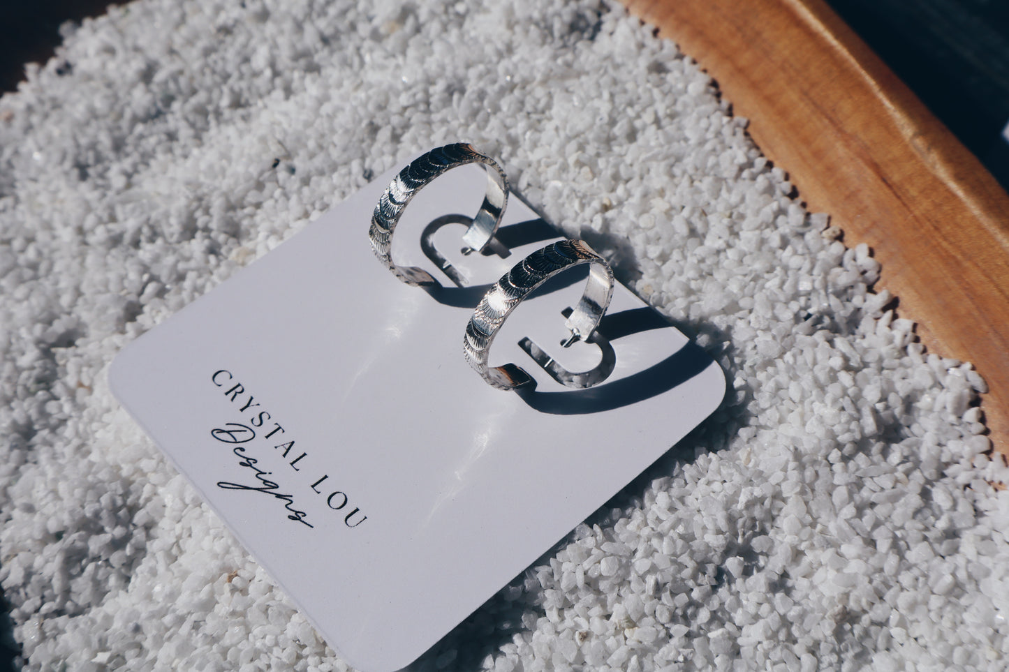 Hand stamped sterling silver “Fish tail” hoop earrings.